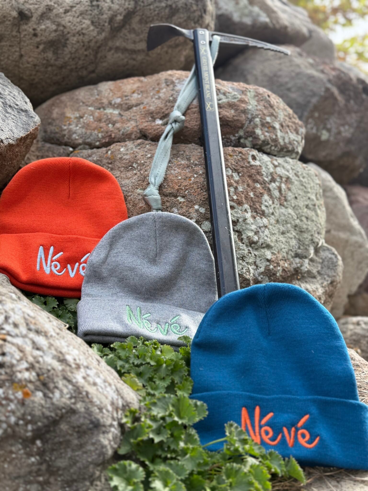 a selection of 3 beanies with Névé embroidered on them, from Gravity Rebel