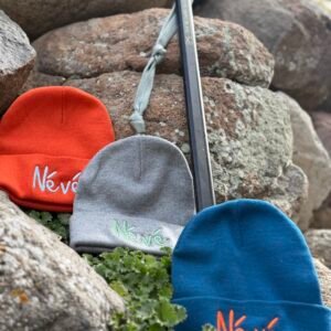 a selection of 3 beanies with Névé embroidered on them, from Gravity Rebel