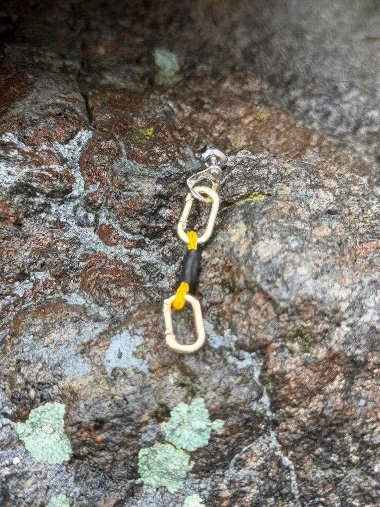 Silver climbing bolt earring with silver carabiner and yellow quickdraw