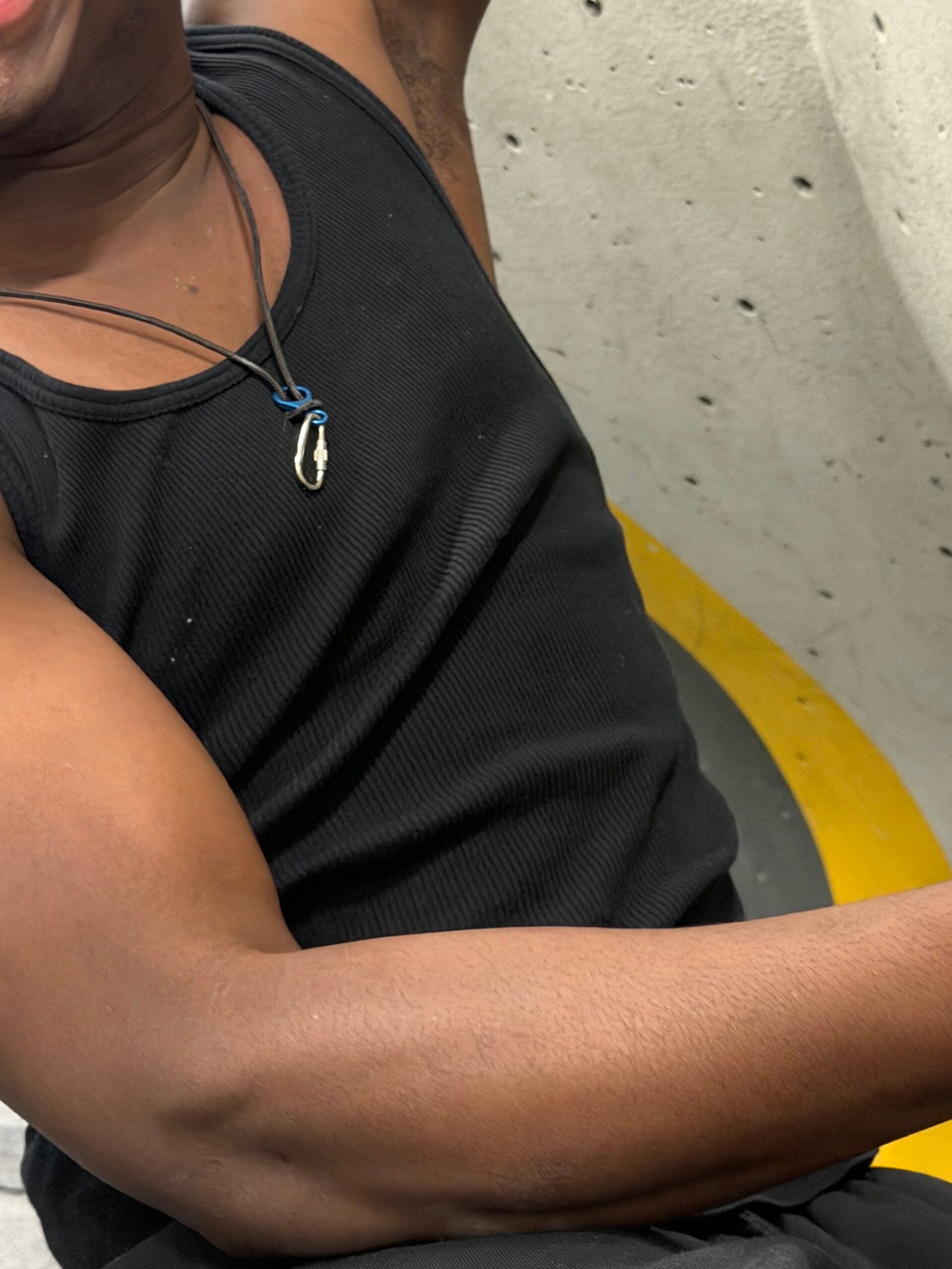 Black rope necklace with blue figure of 8 and locking carabiner