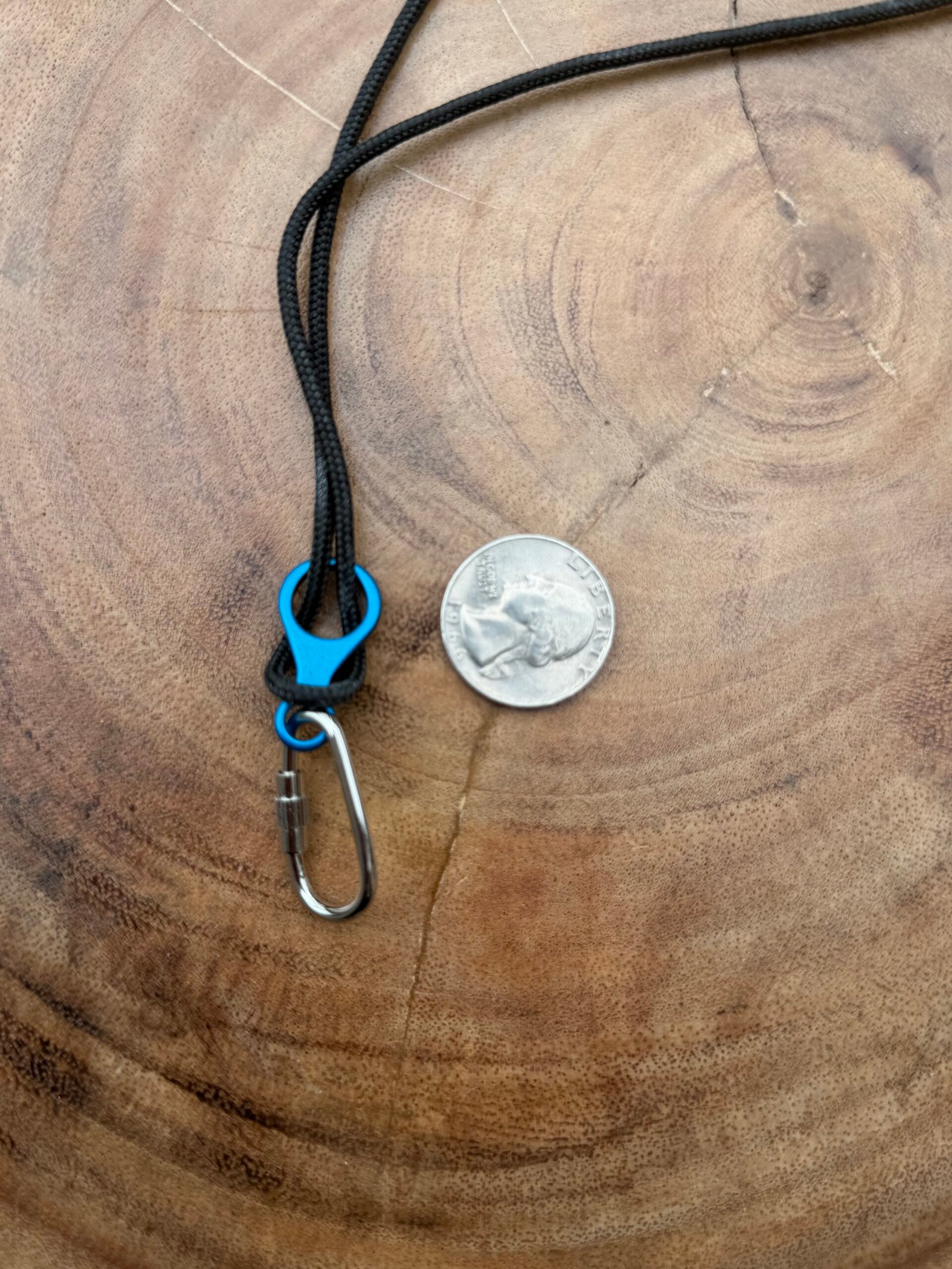 Black rope necklace with blue figure of 8 and locking carabiner